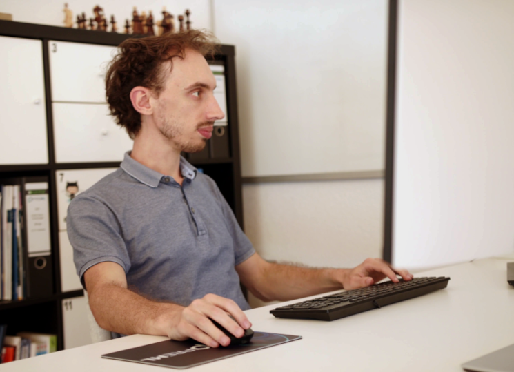 Picture of Lucas Steinmann: sitting at a desk, while looking at a screen